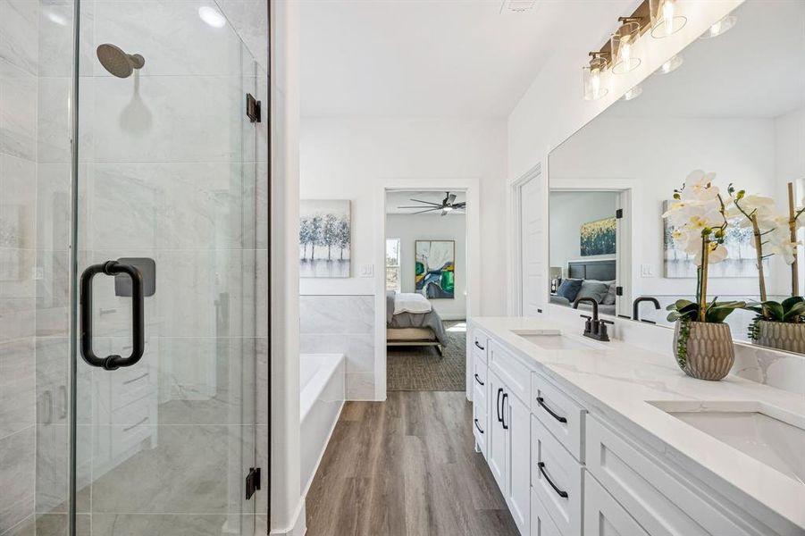 Ensuite primary bathroom with a double vanity and separate shower