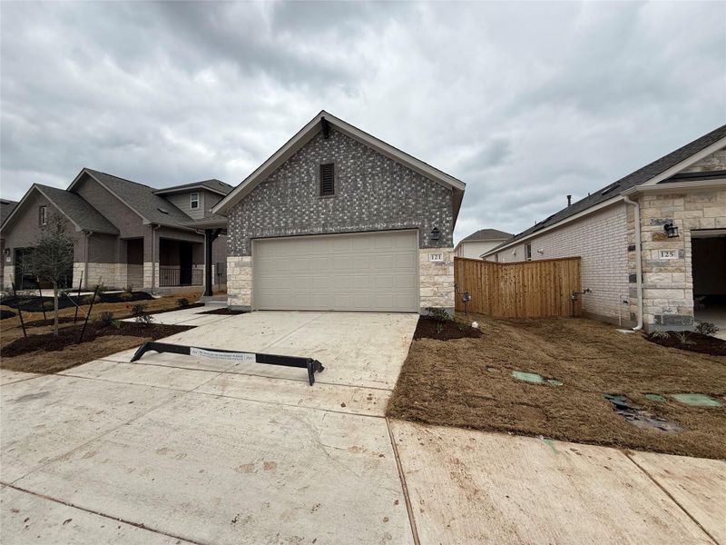 Front exterior of a new home in La Cima, San Marcos, TX, highlighting curb appeal (Image 17).
