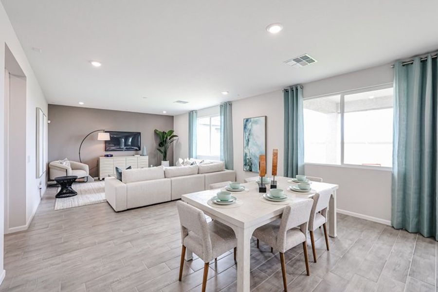 A living room with a table and chairs. A living room with a table and chairs.