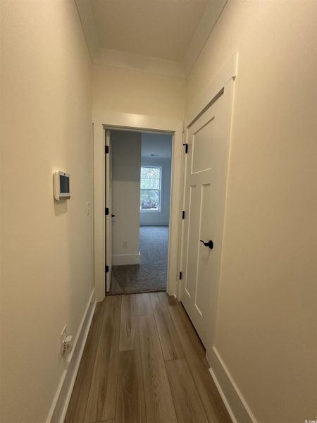 Hall featuring baseboards and light wood-style flooring