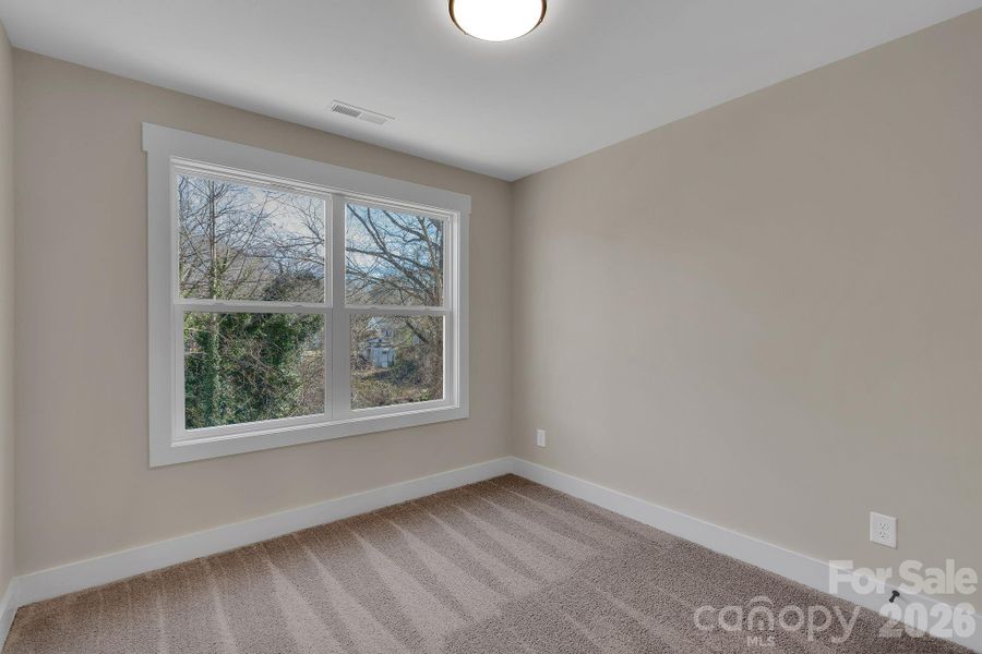 Bedroom 3 - cheerful bedroom designed for family, guests, or a home office, complete with ample closet space.”