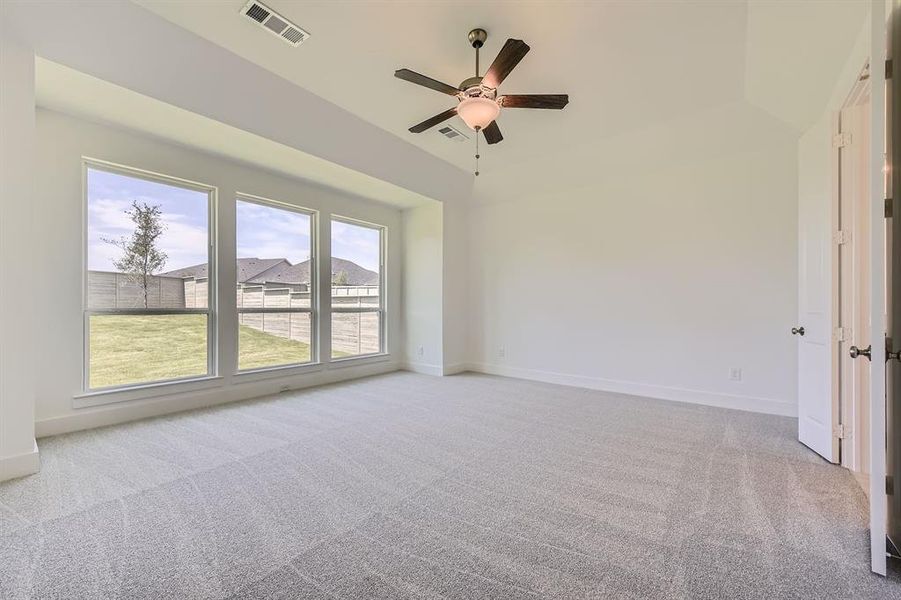 Empty room featuring carpet floors, a ceiling fan, and baseboards Empty room featuring carpet floors, a ceiling fan, and baseboards