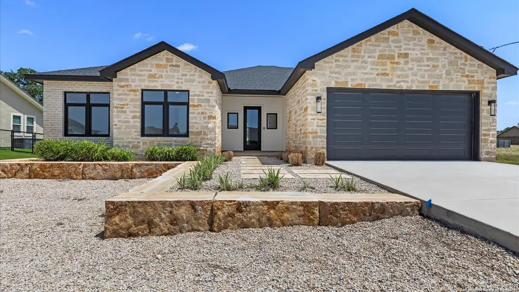 Front exterior of a new home in , Blanco, TX, highlighting curb appeal (Image 1).