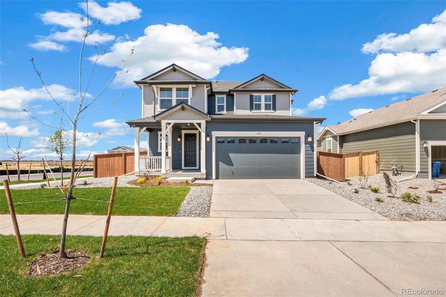 Front exterior of a new home in Farmlore, Brighton, CO, highlighting curb appeal (Image 21).
