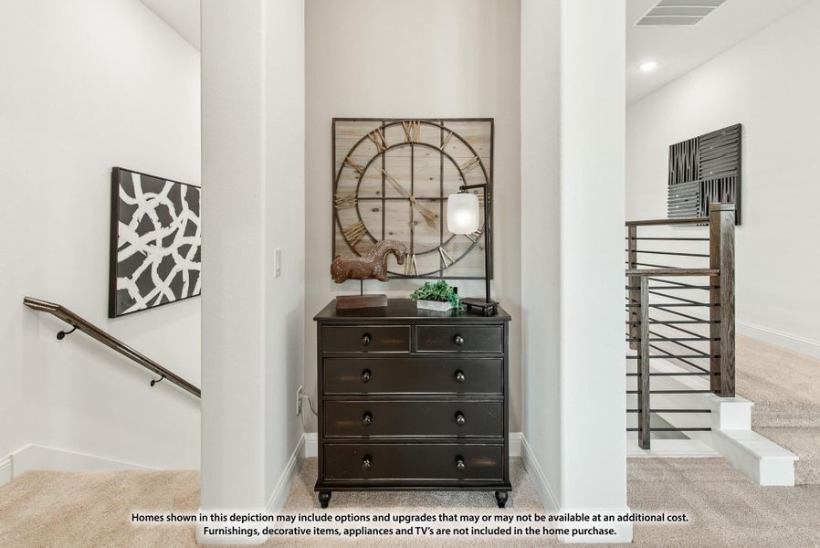 Upstairs hallway landing with dark wood dresser, large decorative clock wall art, and metal stair railing