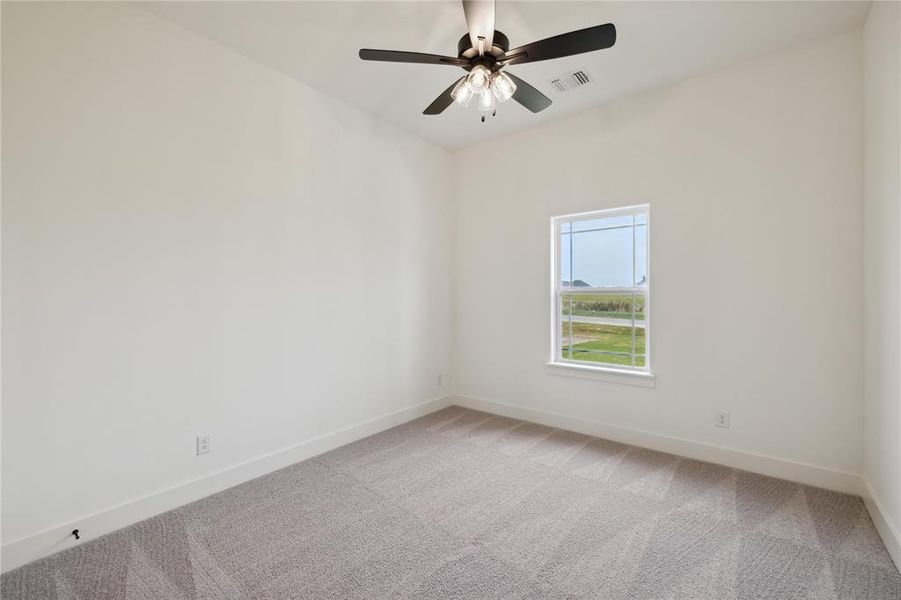 Spare room featuring carpet floors and ceiling fan