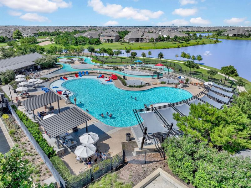 Resort pool with covered cabanas, lounge chairs, picnic tables