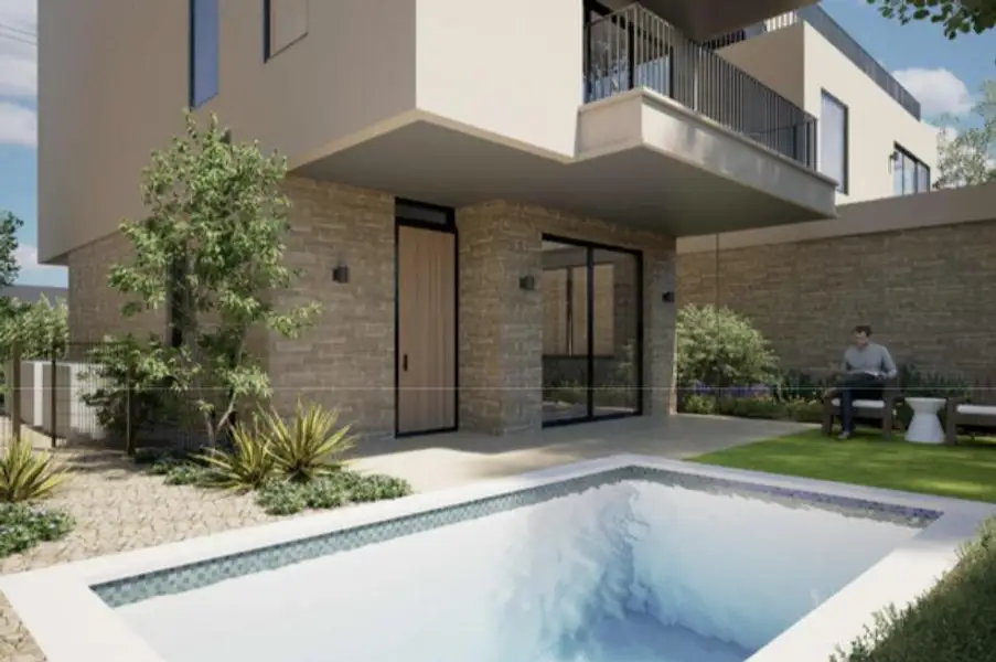 View of pool featuring a balcony and a patio area