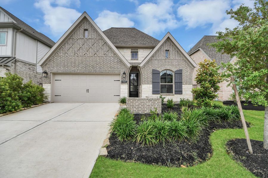 Front exterior of a new home in Bridgeland, Cypress, TX, highlighting curb appeal (Image 25). Front exterior of a new home in Bridgeland, Cypress, TX, highlighting curb appeal (Image 25).