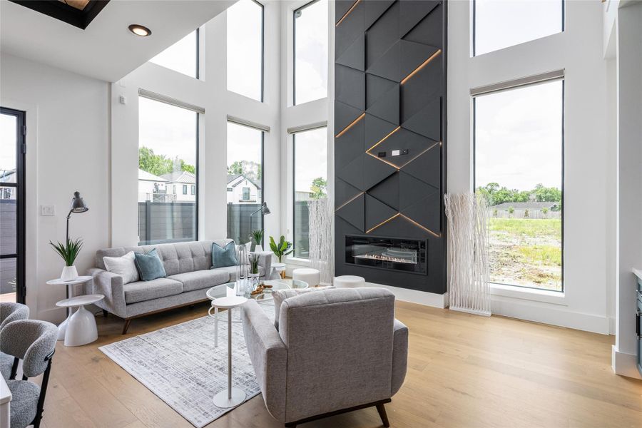 A sleek electric fireplace wrapped in an LED-lit feature wall creates an eye-catching focal point and elevates the living experience A sleek electric fireplace wrapped in an LED-lit feature wall creates an eye-catching focal point and elevates the living experience