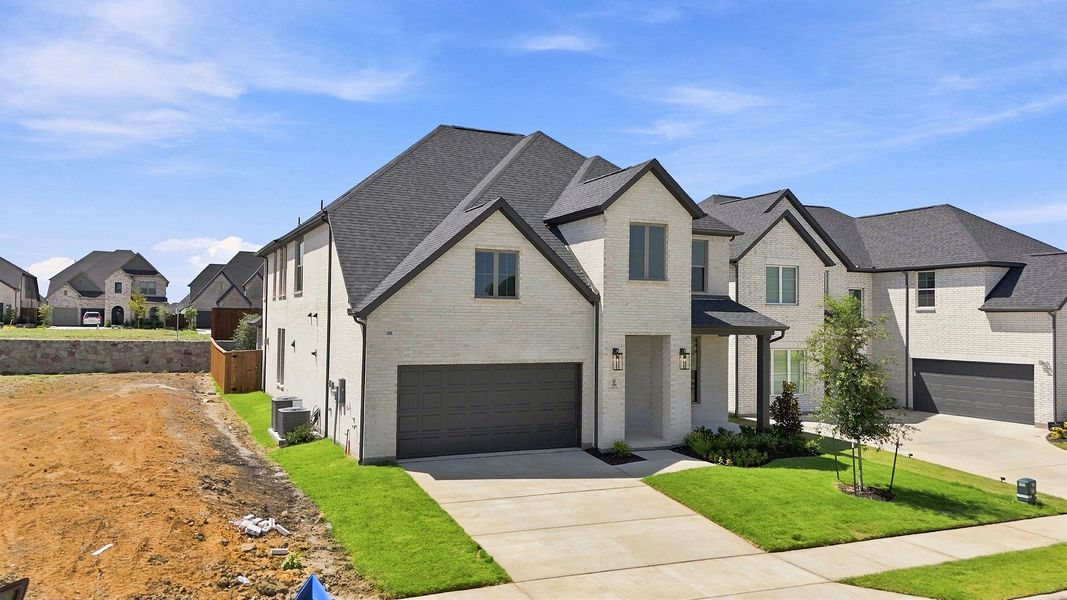 Front exterior of a new home in Hillside Village, Celina, TX, highlighting curb appeal (Image 23). Front exterior of a new home in Hillside Village, Celina, TX, highlighting curb appeal (Image 23).