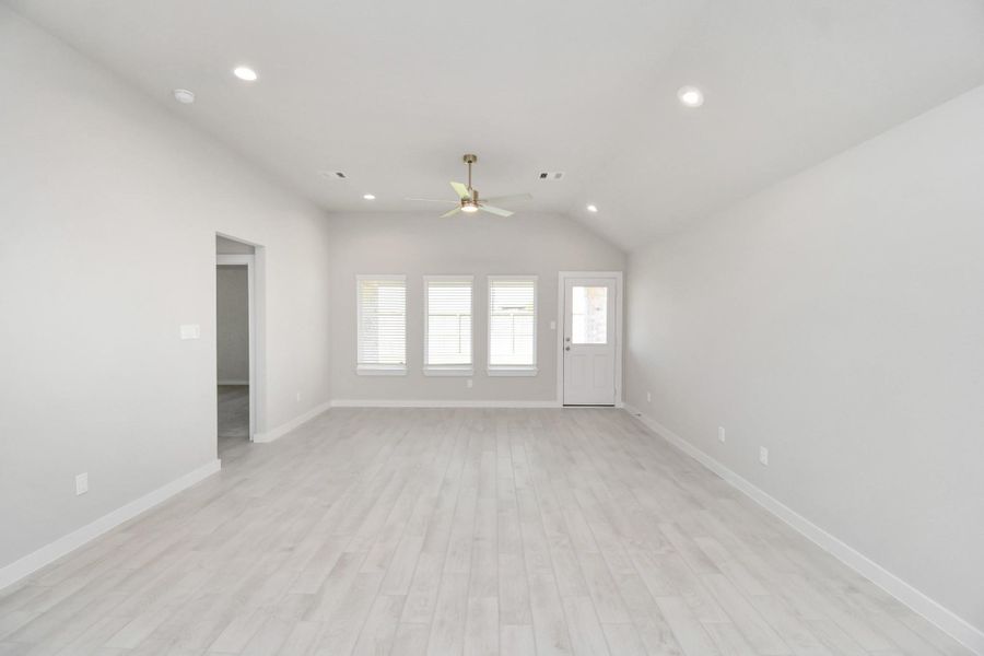 Family room flooded with natural light through the expansive windows. The premium tile flooring adds a touch of luxury to the space, creating the perfect setting for relaxing moments and cherished gatherings with loved ones. Sample photo of completed home with similar floor plan. Actual colors and selections may vary. Family room flooded with natural light through the expansive windows. The premium tile flooring adds a touch of luxury to the space, creating the perfect setting for relaxing moments and cherished gatherings with loved ones. Sample photo of completed home with similar floor plan. Actual colors and selections may vary.