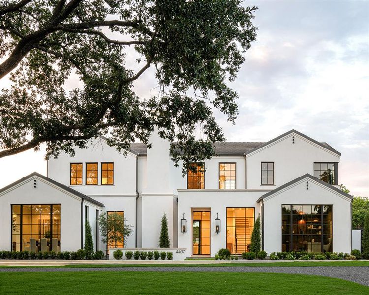 Modern farmhouse featuring a front lawn and stucco siding Modern farmhouse featuring a front lawn and stucco siding