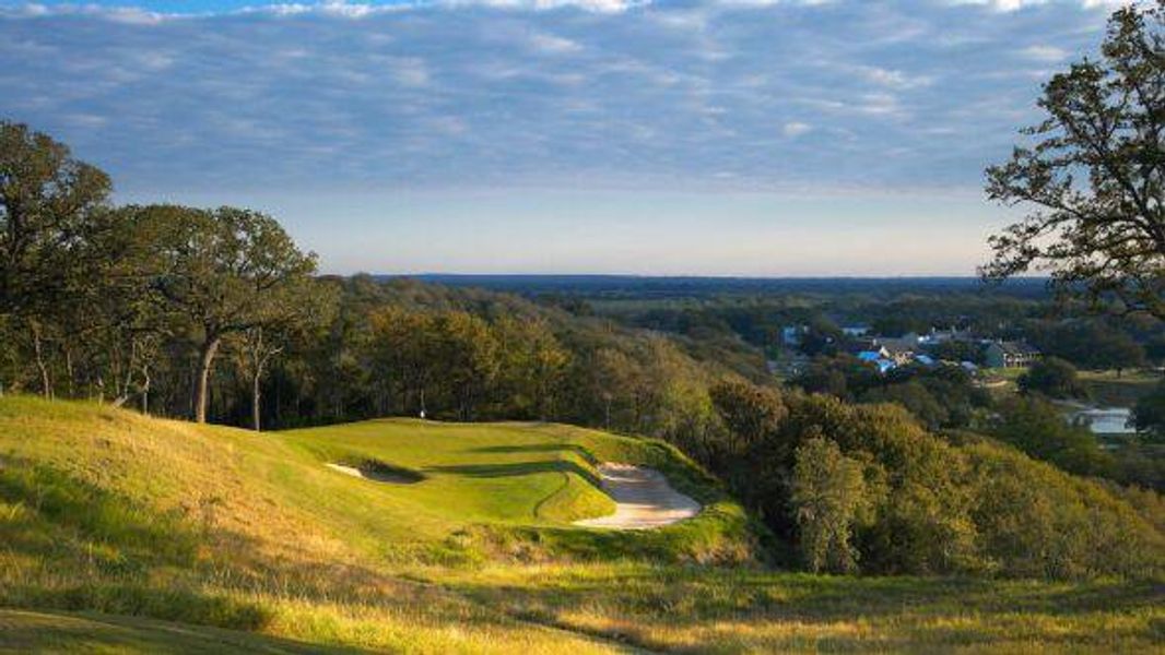 Surrounding community featuring a forest view and golf course view