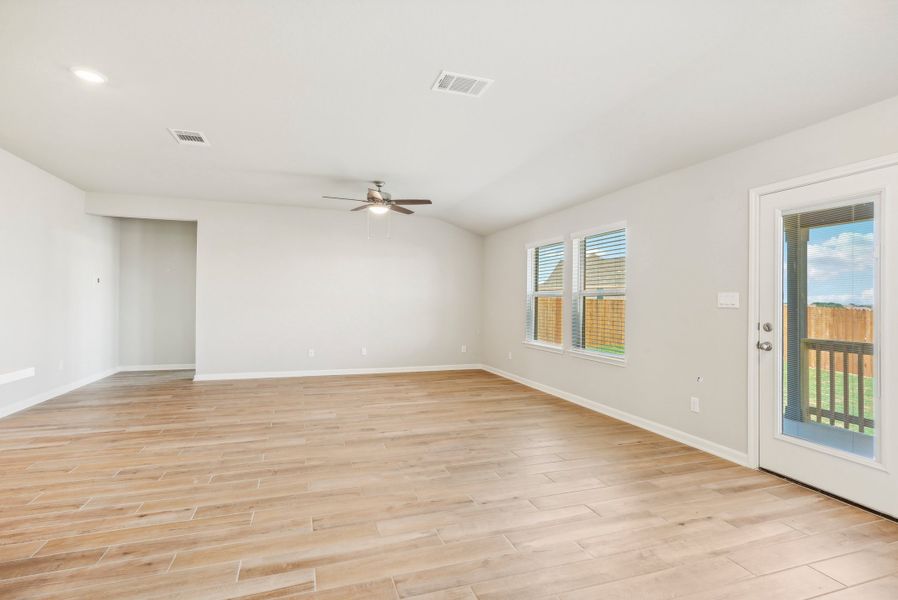 Dining room and living room in the Fitzhugh floorplan at a Meritage homes community.