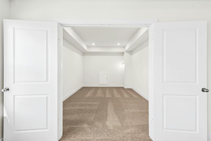Unfurnished room with light colored carpet and recessed lighting