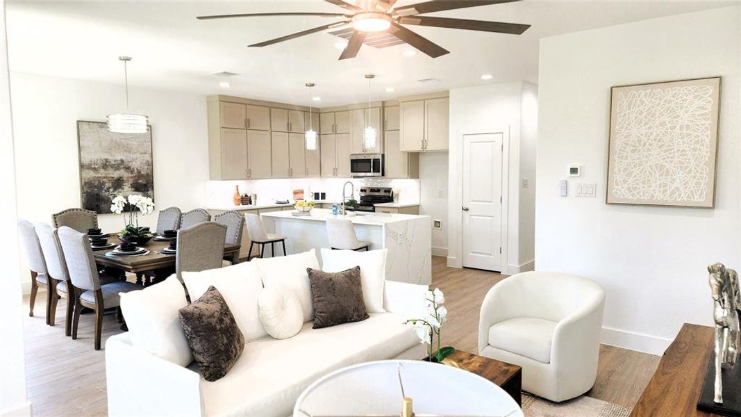 Living area featuring light wood finished floors, recessed lighting, and ceiling fan Living area featuring light wood finished floors, recessed lighting, and ceiling fan