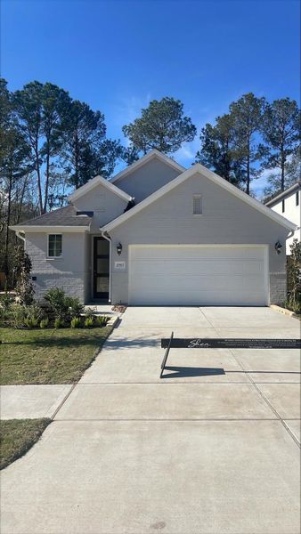 Front exterior of a new home in Woodhavyn 40', Magnolia, TX, highlighting curb appeal (Image 1). Front exterior of a new home in Woodhavyn 40', Magnolia, TX, highlighting curb appeal (Image 1).