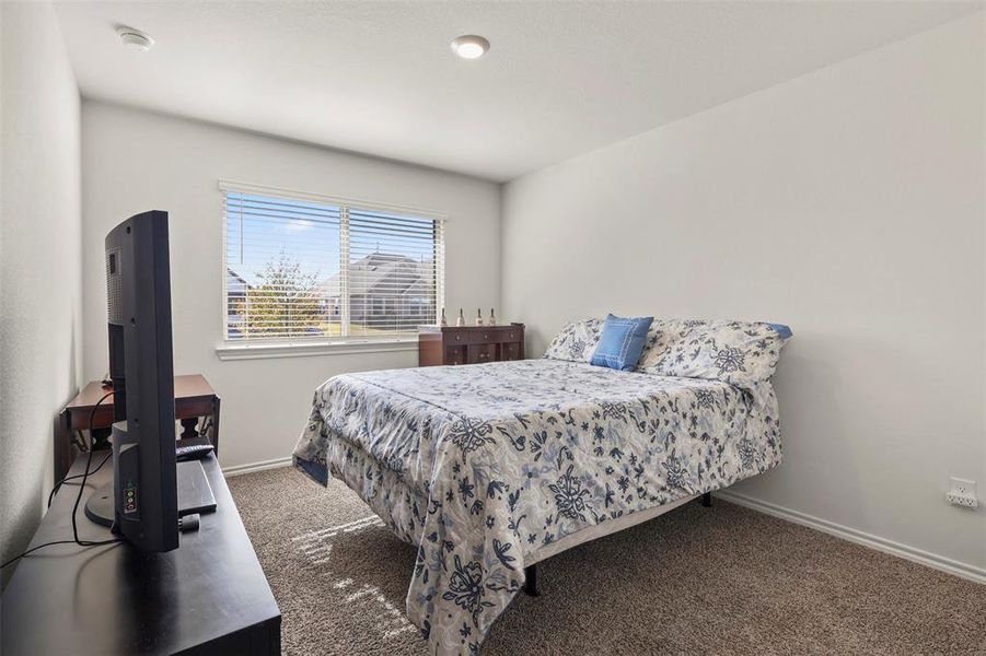 Bedroom featuring carpet flooring and baseboards