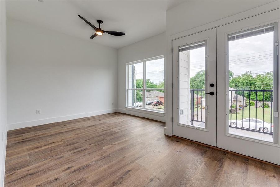Primary bedroom featuring ceiling fan, wood finished floors, and baseboards