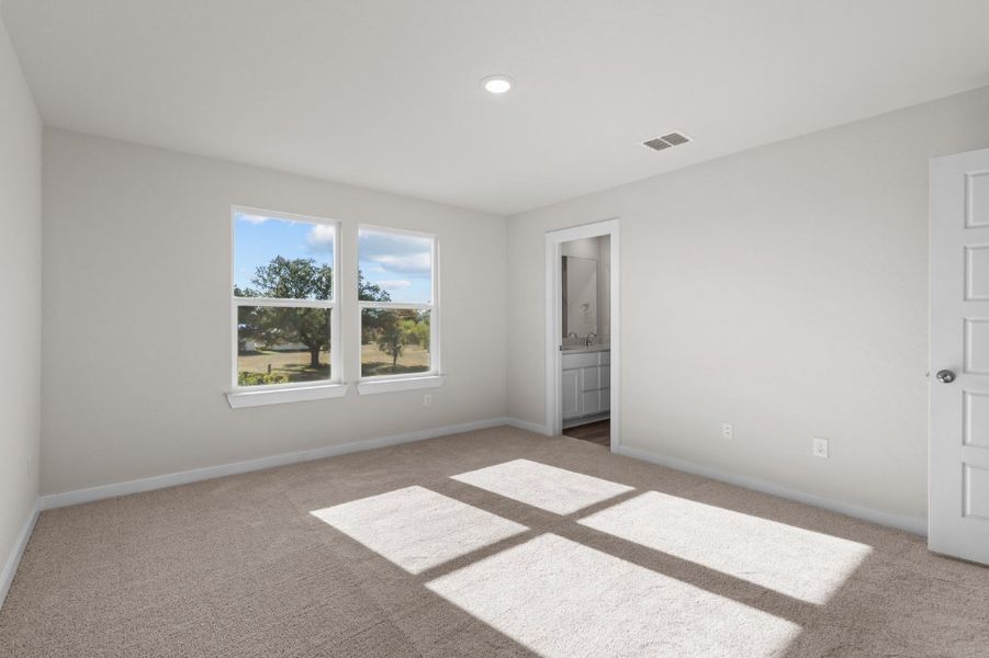 A room with a rug and a window. A room with a rug and a window.