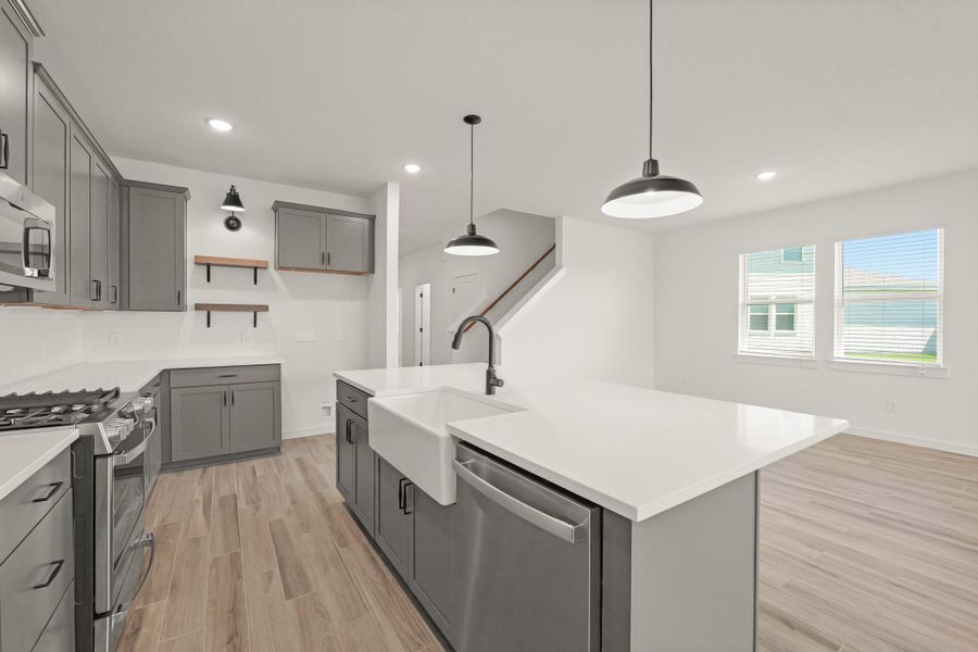 Kitchen with grey cabinet and quartz counters