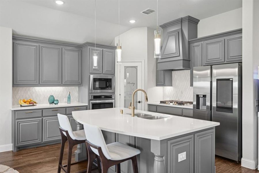 Kitchen featuring gray cabinetry, appliances with stainless steel finishes, tasteful backsplash, dark wood finished floors, and recessed lighting Kitchen featuring gray cabinetry, appliances with stainless steel finishes, tasteful backsplash, dark wood finished floors, and recessed lighting