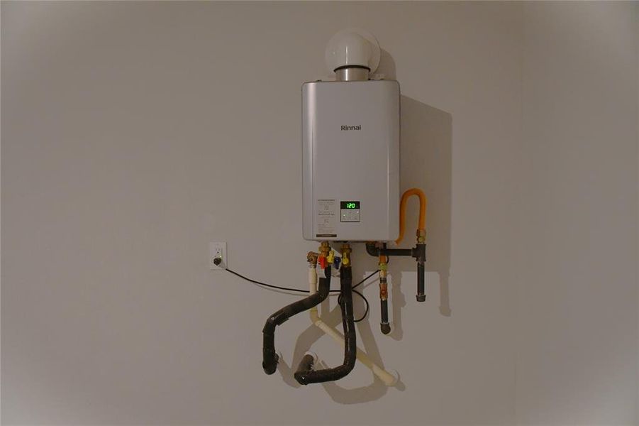 This photo shows a modern, wall-mounted tankless water heater, offering efficient on-demand hot water for the home.