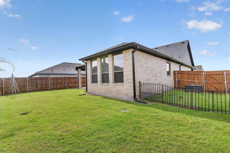 Expansive backyard featuring a manicured lawn