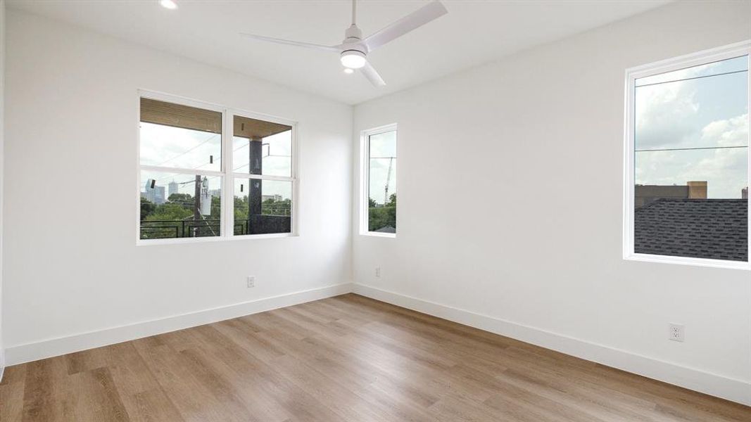 Spare room featuring ceiling fan and light wood-type flooring