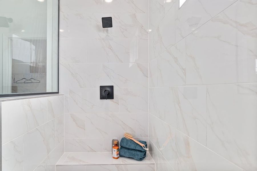 A bathroom with a tile wall.