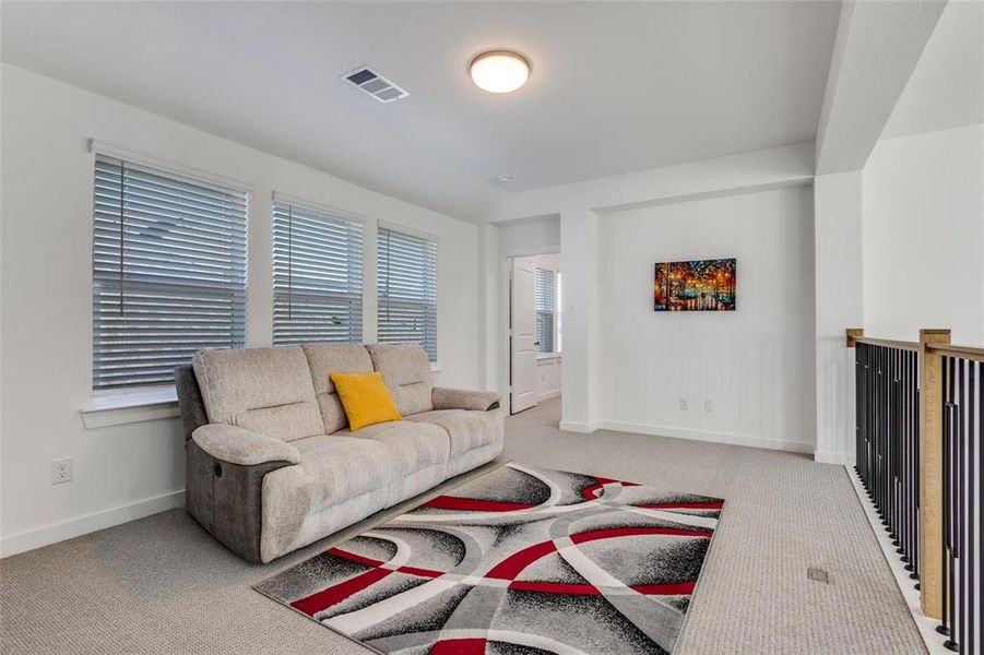 Living room featuring light carpet and baseboards Living room featuring light carpet and baseboards