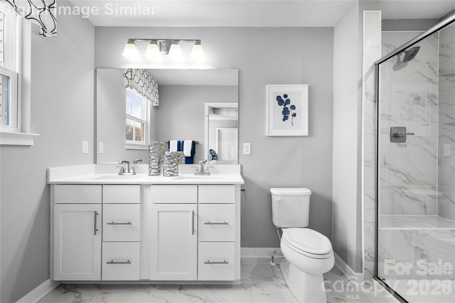 Love where you unwind—this sunlit primary bath features his-and-hers sinks, elegant finishes, and an optional Roman shower with a framed glass door for a spa-like touch. Love where you unwind—this sunlit primary bath features his-and-hers sinks, elegant finishes, and an optional Roman shower with a framed glass door for a spa-like touch.