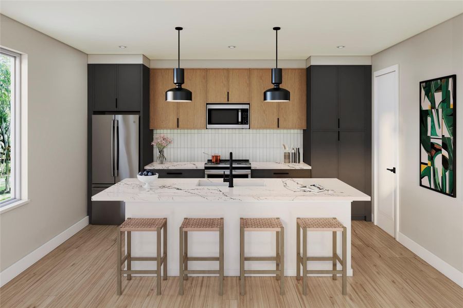 Kitchen with a kitchen bar, light stone counters, a kitchen island with sink, appliances with stainless steel finishes, and decorative light fixtures