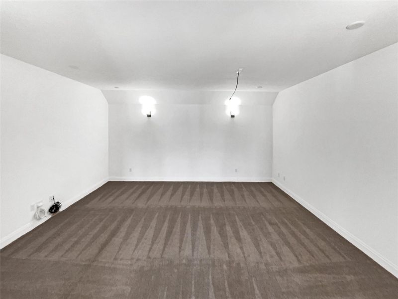 Empty room featuring baseboards and carpet