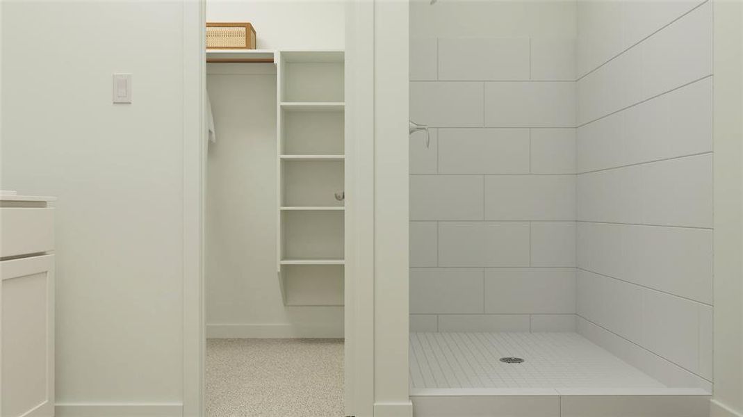 Bathroom featuring vanity and tiled shower