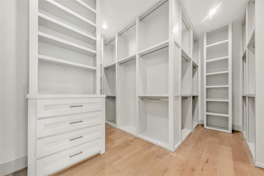 Spacious closet with light wood finished floors