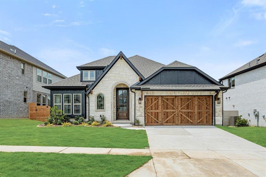 Front exterior of a new home in Painted Tree Woodland District 50, McKinney, TX, highlighting curb appeal (Image 25). Front exterior of a new home in Painted Tree Woodland District 50, McKinney, TX, highlighting curb appeal (Image 25).