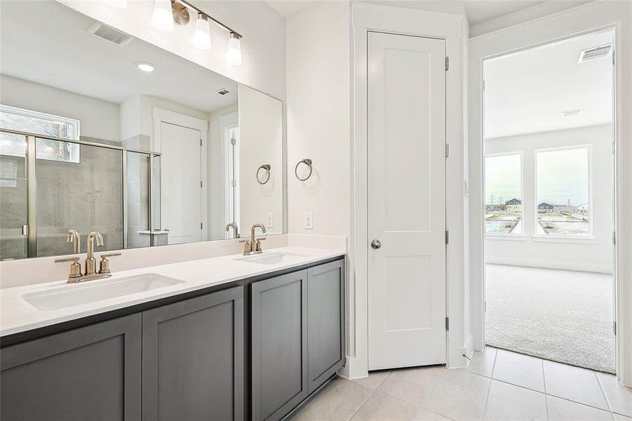 Bathroom featuring double vanity and tile patterned flooring