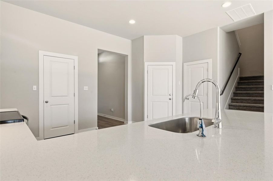 Kitchen with recessed lighting, light stone counters, and electric range Kitchen with recessed lighting, light stone counters, and electric range