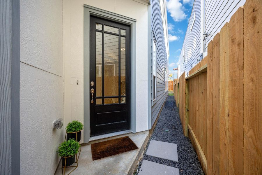 A Warm Welcome, Every Time This charming side-entry sets the tone with clean lines, fresh landscaping, and a modern glass-paneled door that fills the foyer with natural light.
