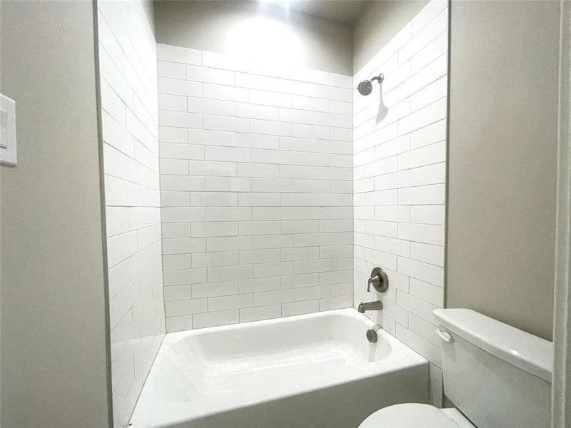 Bathroom featuring toilet and tub / shower combination