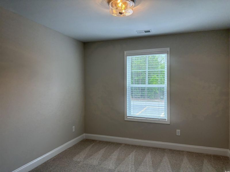 Spare room with carpet floors and baseboards