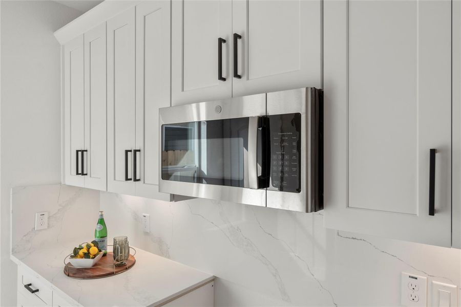 The kitchen features a sleek built-in microwave that blends seamlessly with the cabinetry for a modern, streamlined look. The kitchen features a sleek built-in microwave that blends seamlessly with the cabinetry for a modern, streamlined look.