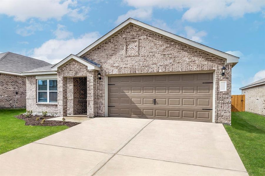 View of front facade with a garage and a front lawn