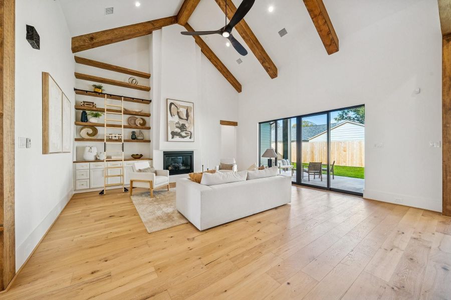 This room might render you speechless. From the 20 ft vaulted ceiling to the floating shelves and rolling library ladder, no detail has been left out. The doors slide apart for a seamless indoor/outdoor lifestyle.