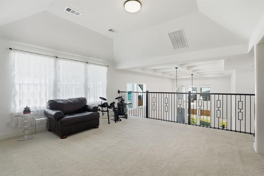 Sitting room with carpet floors, beam ceiling, coffered ceiling, and a chandelier Sitting room with carpet floors, beam ceiling, coffered ceiling, and a chandelier