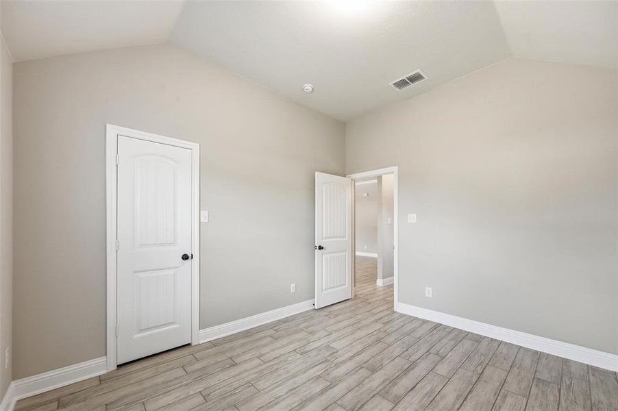 Unfurnished bedroom with light wood-style flooring and baseboards Unfurnished bedroom with light wood-style flooring and baseboards