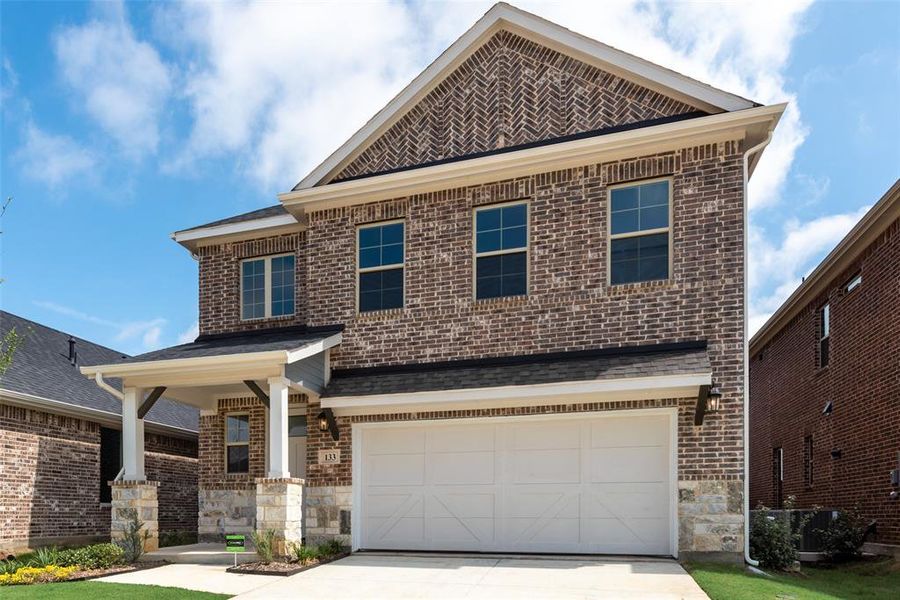 Front exterior of a new home in Spiritas Ranch, Little Elm, TX, highlighting curb appeal (Image 1).