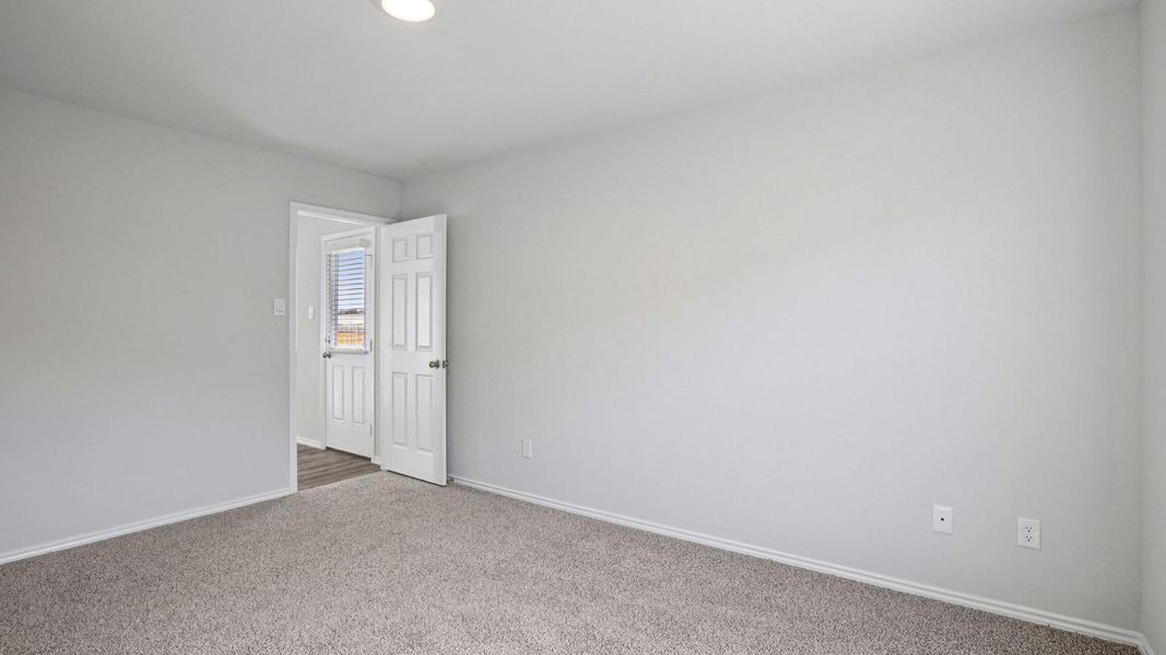 A spacious room offers comfortable carpeting and a doorway leading to new adventures. A spacious room offers comfortable carpeting and a doorway leading to new adventures.